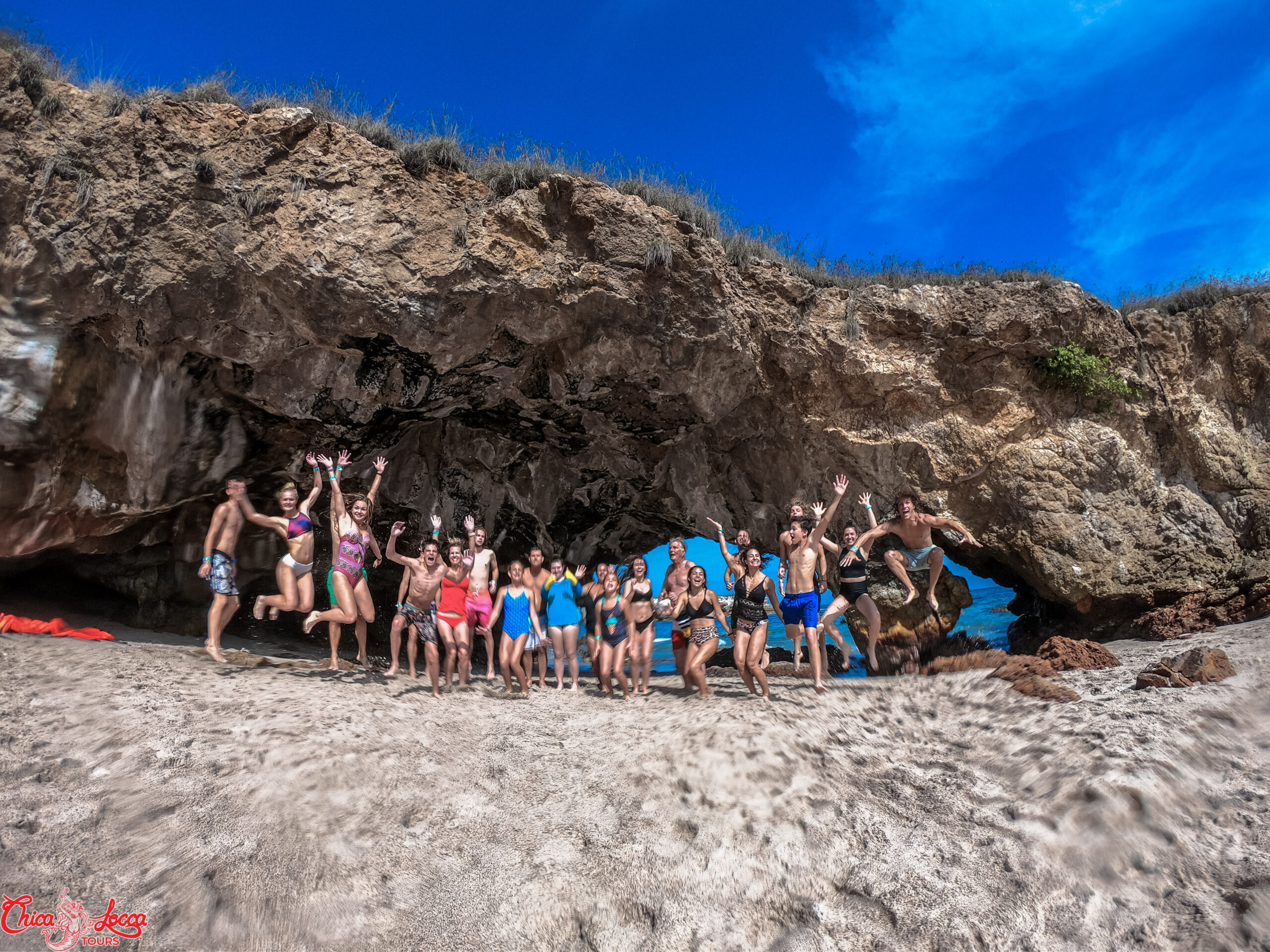 group jumping at hidden beach